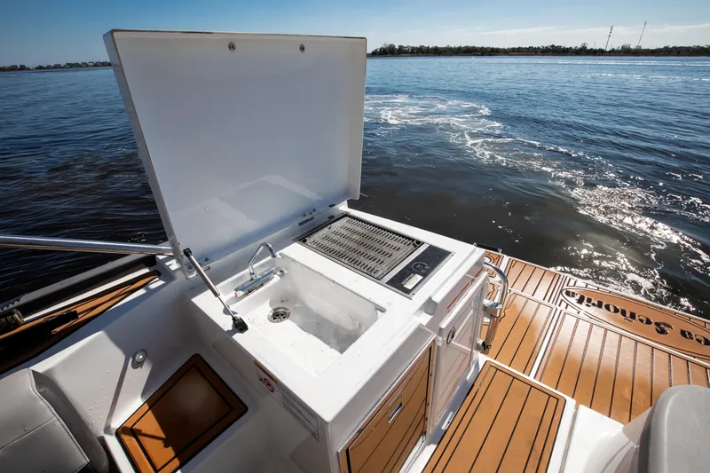  Yacht Photos Pics 2021 Beneteau Gran Turismo 36 outdoor kitchen on deck with sink and grill.