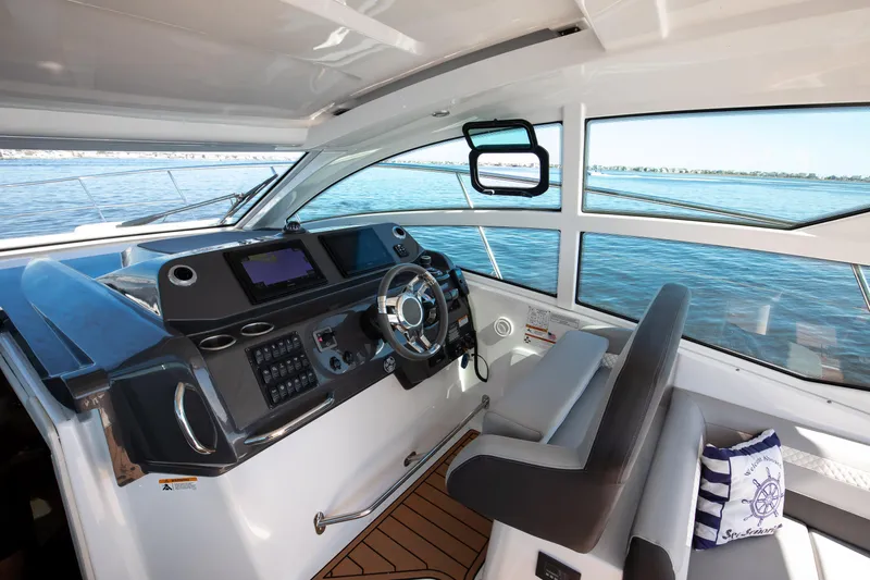  Yacht Photos Pics Interior helm of 2021 Beneteau Gran Turismo 36 yacht with modern controls and panoramic windows.