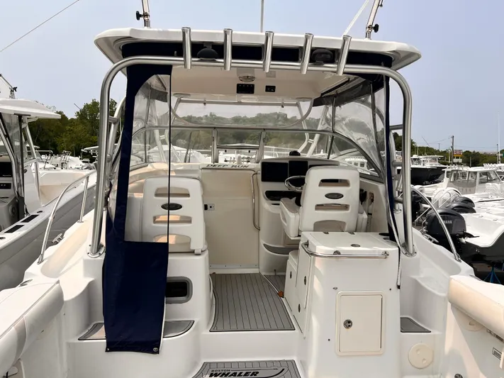  Yacht Photos Pics 2005 Boston Whaler 305 Conquest boat interior with seating and helm station.