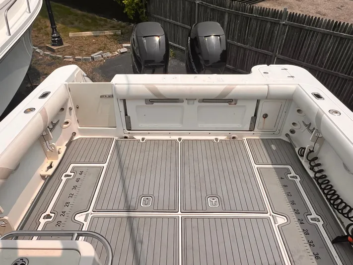  Yacht Photos Pics 2005 Boston Whaler 305 Conquest boat deck with dual outboard motors and spacious seating area.