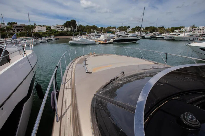  Yacht Photos Pics 2009 Riva 52 Rivale yacht docked in a marina, surrounded by other boats.