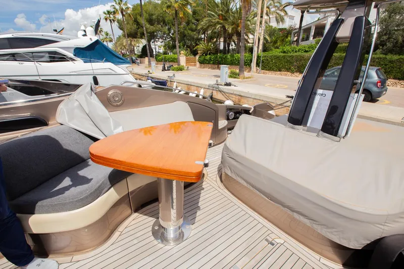  Yacht Photos Pics 2009 Riva 52 Rivale yacht deck with seating and wooden table.