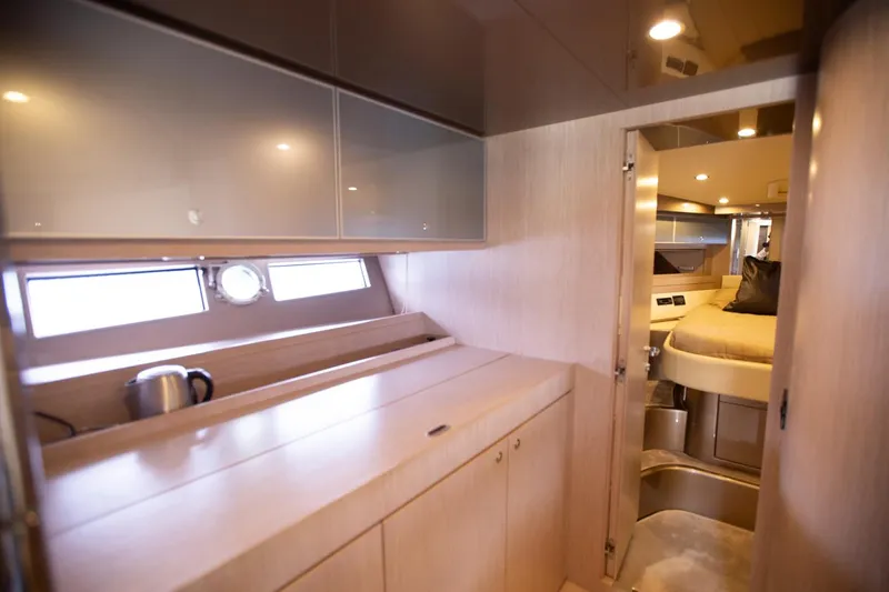  Yacht Photos Pics Interior of 2009 Riva 52 Rivale yacht, featuring modern cabinetry and cozy sleeping area.