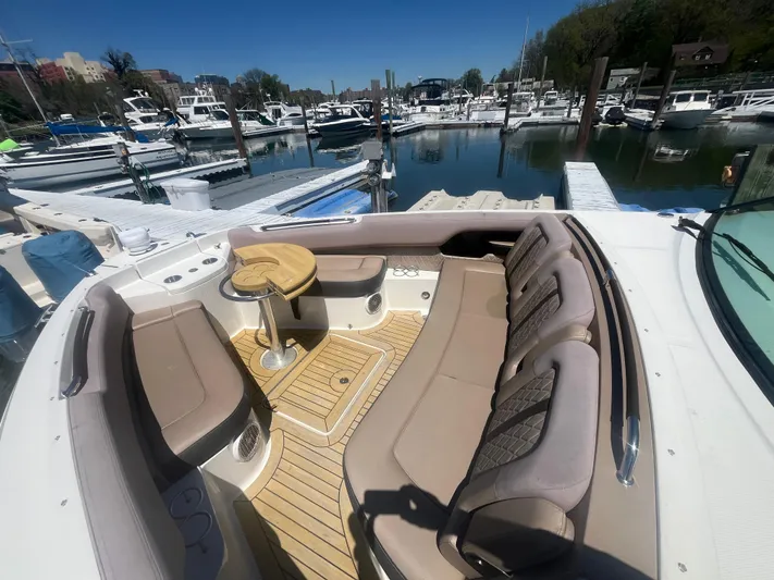  Yacht Photos Pics 2018 Sea Ray SLX 400 boat interior with beige seating at a marina.