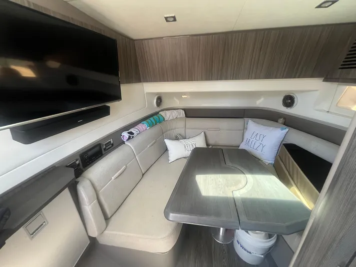  Yacht Photos Pics 2018 Sea Ray SLX 400 interior with seating, table, and mounted TV.