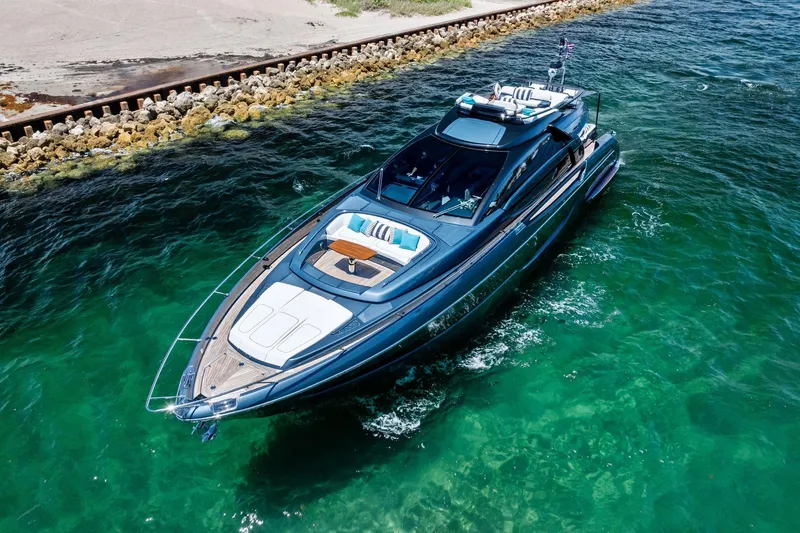Momentum Yacht Photos Pics Luxurious 2024 Riva 76 PERSEO Super yacht cruising in clear turquoise waters.
