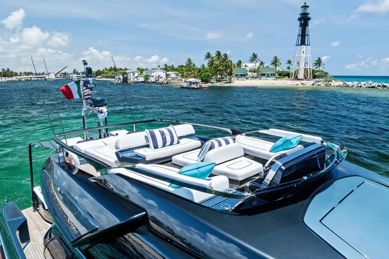 Momentum Yacht Photos Pics Luxurious 2024 Riva 76 PERSEO Super yacht near a scenic lighthouse and tropical island.