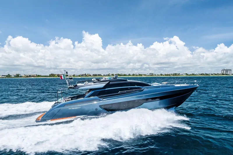 Momentum Yacht Photos Pics 2024 Riva 76 PERSEO Super yacht cruising on open water under a clear blue sky.