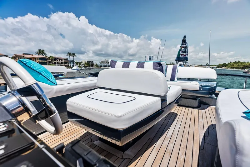 Momentum Yacht Photos Pics Luxurious 2024 Riva 76 PERSEO Super yacht deck with plush seating and scenic waterfront view.