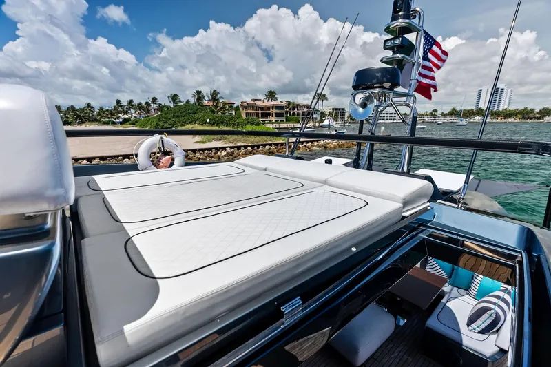 Momentum Yacht Photos Pics Luxurious 2024 Riva 76 PERSEO Super yacht with sunbathing deck and scenic waterfront view.