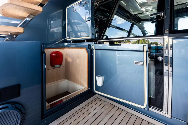 Momentum Yacht Photos Pics 2024 Riva 76 PERSEO Super yacht interior with sleek blue doors and wooden flooring.