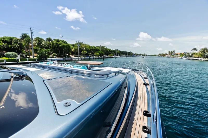 Momentum Yacht Photos Pics 2024 Riva 76 PERSEO Super yacht cruising on a scenic waterway.