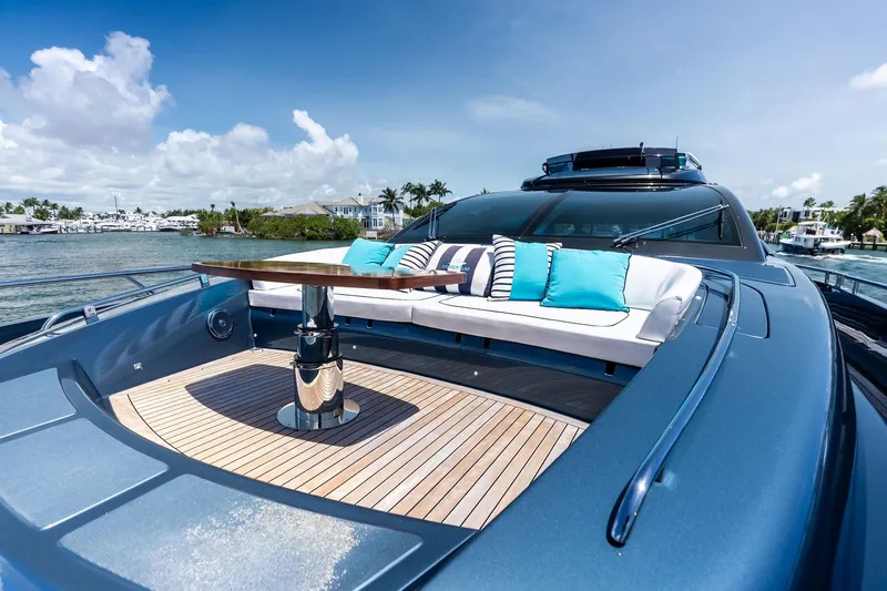 Momentum Yacht Photos Pics Luxurious 2024 Riva 76 PERSEO Super yacht with elegant deck seating and scenic waterfront view.