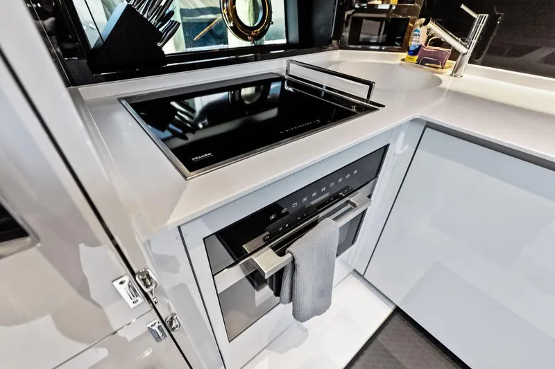 Momentum Yacht Photos Pics Modern kitchen interior of 2024 Riva 76 PERSEO Super yacht with sleek appliances.