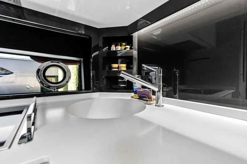 Momentum Yacht Photos Pics Luxurious kitchen interior of 2024 Riva 76 PERSEO Super yacht with modern sink and porthole.