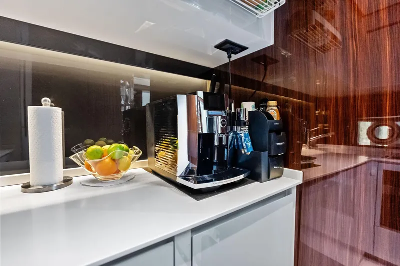 Momentum Yacht Photos Pics Luxurious kitchen area in 2024 Riva 76 PERSEO Super yacht with coffee machine and fruit bowl.