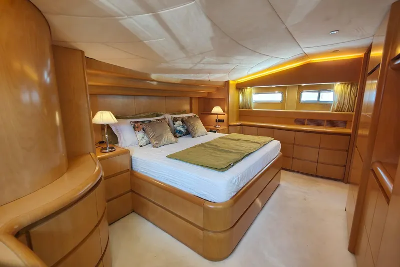 Lady A Yacht Photos Pics Luxurious bedroom interior of 2000 Maiora 29 DP yacht with elegant wood finish.