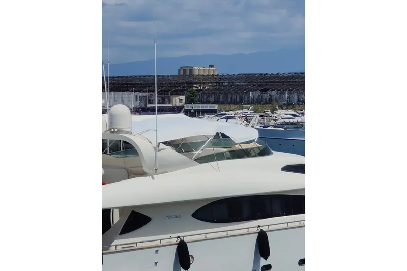 Lady A Yacht Photos Pics Luxury yacht Maiora 29 DP, 2000 model, docked in a marina under a clear sky.
