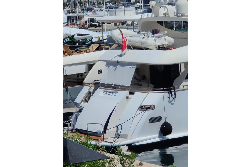 Lady A Yacht Photos Pics Luxury yacht Maiora 29 DP, 2000 model, docked in a marina with flag and tender.