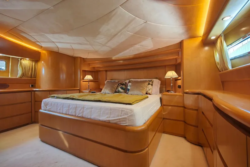 Lady A Yacht Photos Pics Luxurious bedroom interior of 2000 Maiora 29 DP yacht with elegant wood finish.
