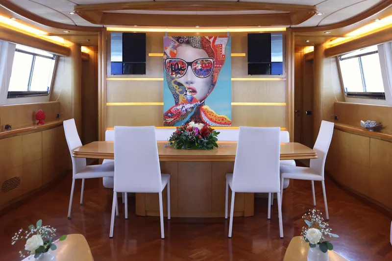 Lady A Yacht Photos Pics Luxurious dining area on 2000 Maiora 29 DP yacht with modern art and elegant decor.