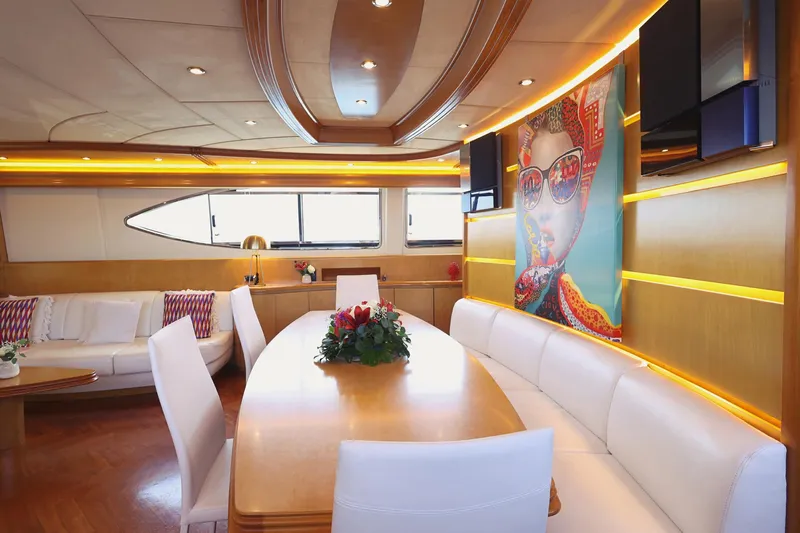 Lady A Yacht Photos Pics Luxurious interior of 2000 Maiora 29 DP yacht with modern decor and vibrant artwork.