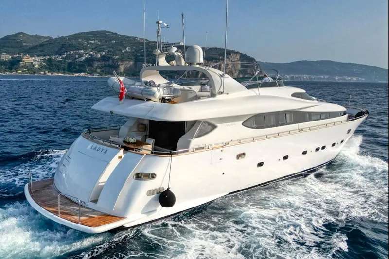 Lady A Yacht Photos Pics Luxury Maiora 29 DP yacht cruising on the ocean, 2000 model, scenic coastal backdrop.