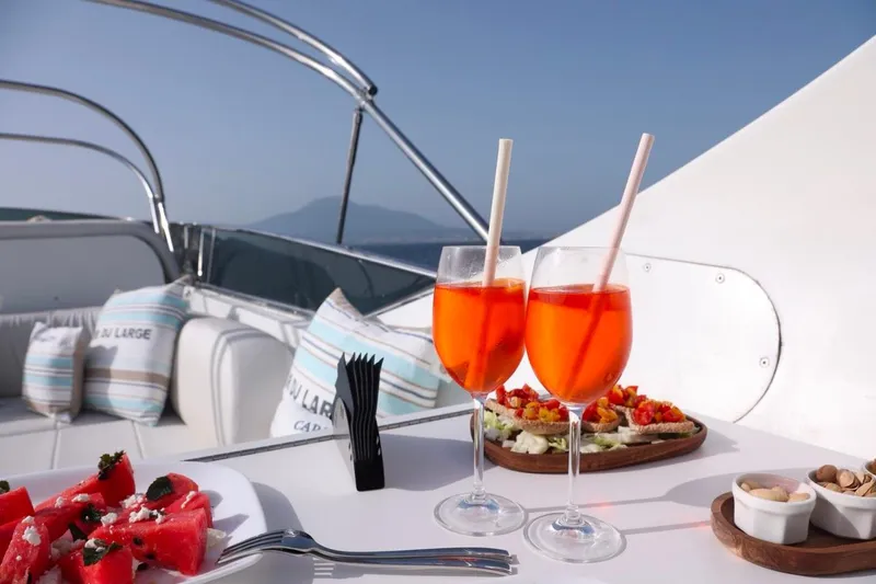 Lady A Yacht Photos Pics Luxurious Maiora 29 DP yacht deck with drinks, snacks, and scenic ocean view.