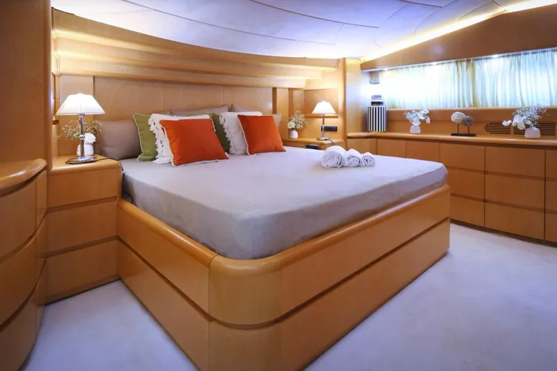 Lady A Yacht Photos Pics Luxurious bedroom interior of 2000 Maiora 29 DP yacht with elegant wood furnishings.