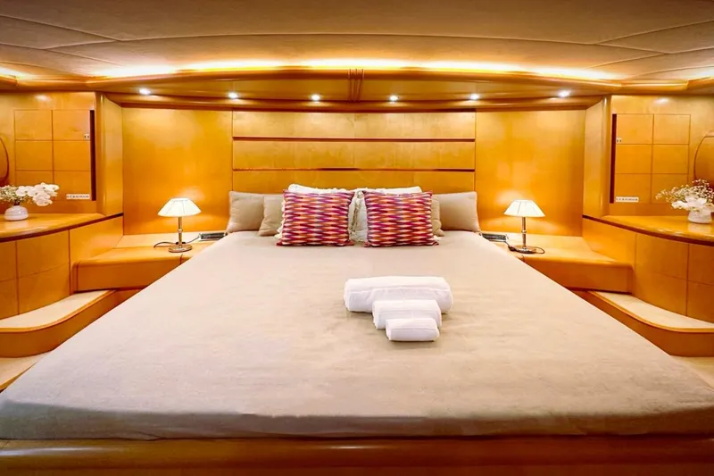 Lady A Yacht Photos Pics Luxurious bedroom interior of 2000 Maiora 29 DP yacht with elegant lighting and decor.
