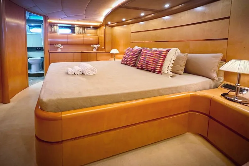 Lady A Yacht Photos Pics Luxurious Maiora 29 DP yacht bedroom with elegant wood finish and cozy lighting, 2000 model.