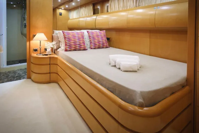 Lady A Yacht Photos Pics Luxurious Maiora 29 DP yacht bedroom interior, 2000 model, with elegant wood finish and cozy lighting.