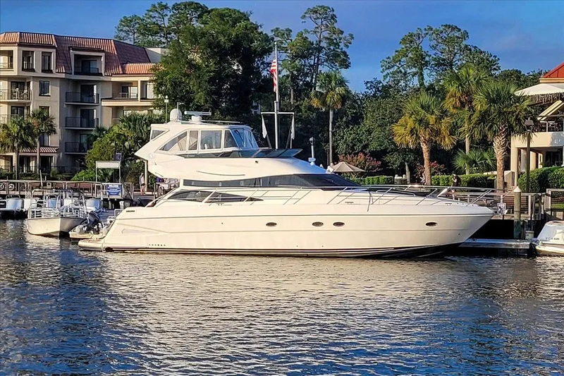 Vortex Yacht Photos Pics Luxury 2004 Neptunus 56 Flybridge yacht docked near waterfront buildings.