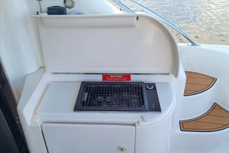 Vortex Yacht Photos Pics Outdoor grill on 2004 Neptunus 56 Flybridge yacht deck, near water.