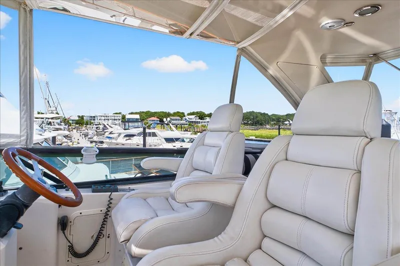 Vortex Yacht Photos Pics Luxurious Neptunus 56 Flybridge yacht interior with plush white seating, 2004 model.