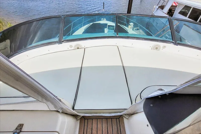 Vortex Yacht Photos Pics 2004 Neptunus 56 Flybridge yacht deck with glass railing and water view.