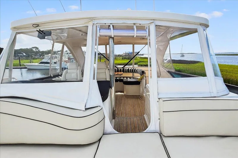 Vortex Yacht Photos Pics 2004 Neptunus 56 Flybridge yacht with spacious seating and scenic waterway view.