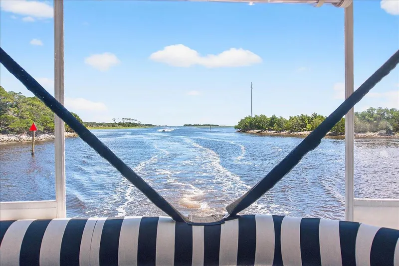 Vortex Yacht Photos Pics View from Neptunus 56 Flybridge yacht, 2004, showing serene waterway and lush greenery.