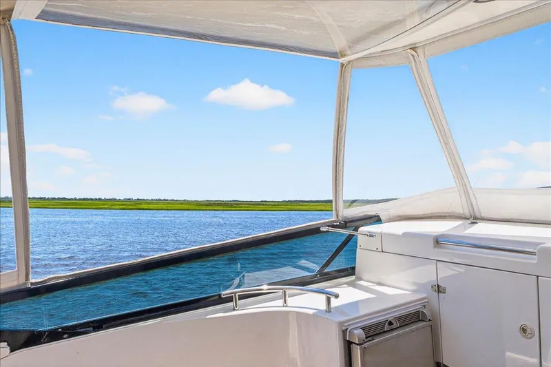 Vortex Yacht Photos Pics View from 2004 Neptunus 56 Flybridge yacht, overlooking serene water and clear sky.