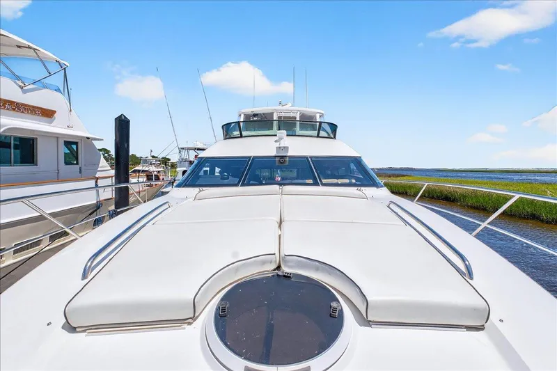 Vortex Yacht Photos Pics 2004 Neptunus 56 Flybridge yacht docked, showcasing sleek design and spacious deck.