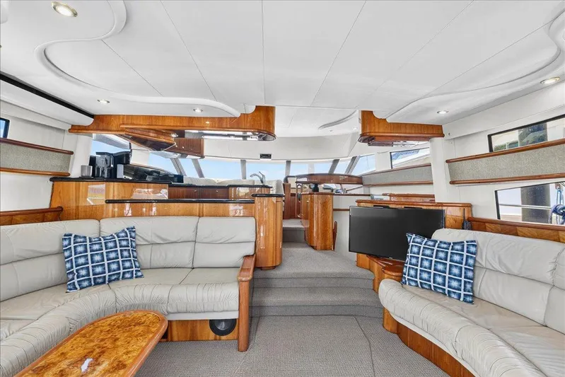 Vortex Yacht Photos Pics Luxurious interior of 2004 Neptunus 56 Flybridge yacht with elegant seating and modern design.