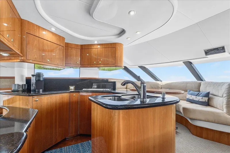 Vortex Yacht Photos Pics Luxurious interior of 2004 Neptunus 56 Flybridge yacht with modern kitchen and seating area.