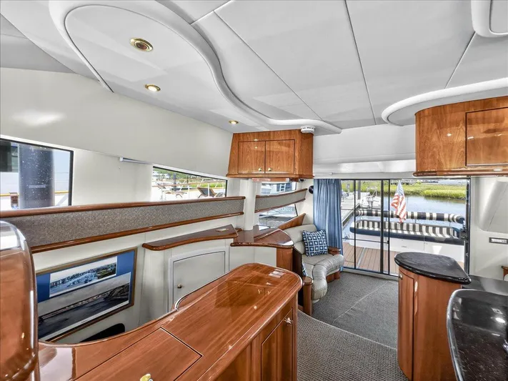 Vortex Yacht Photos Pics Luxurious 2004 Neptunus 56 Flybridge yacht interior with elegant wood finishes and spacious seating.