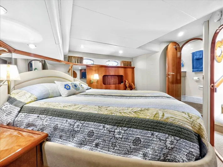 Vortex Yacht Photos Pics Luxurious bedroom interior of 2004 Neptunus 56 Flybridge yacht with elegant bedding.
