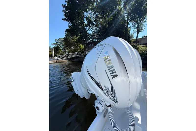  Yacht Photos Pics Yamaha outboard engine on 2021 Jupiter 38 HFS boat, docked by trees.