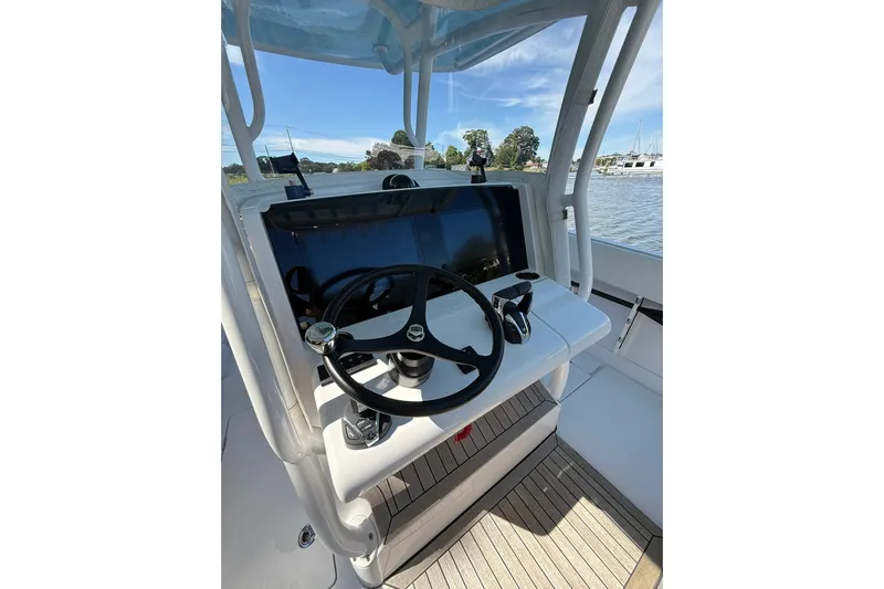  Yacht Photos Pics 2021 Jupiter 38 HFS boat helm with steering wheel and controls, docked by the water.
