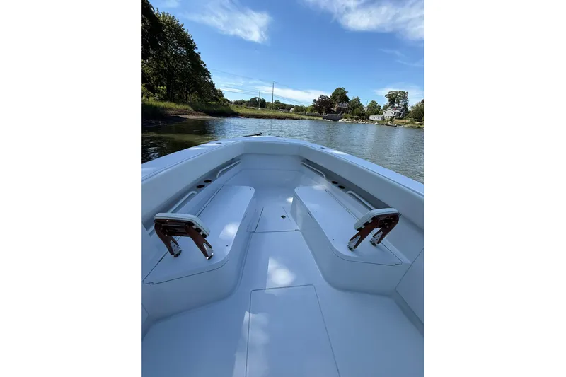  Yacht Photos Pics 2021 Jupiter 38 HFS boat interior with seating, on a calm river under blue sky.