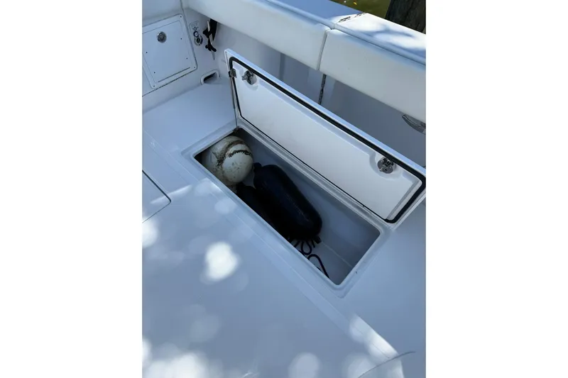  Yacht Photos Pics Open storage compartment on 2021 Jupiter 38 HFS boat, containing fenders and a buoy.