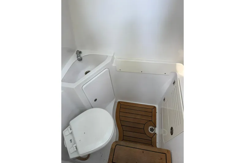  Yacht Photos Pics 2021 Jupiter 38 HFS boat bathroom with sink, toilet, and wooden floor.