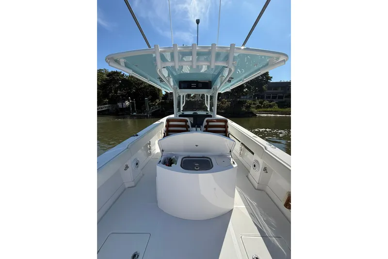  Yacht Photos Pics 2021 Jupiter 38 HFS boat interior with seating and console, under a clear blue sky.